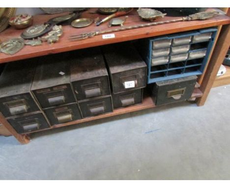 A shelf of workshop drawers and contents