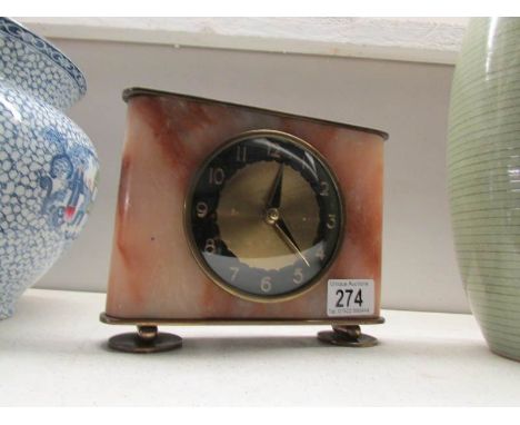 An art deco brass and marble mantel clock in working order