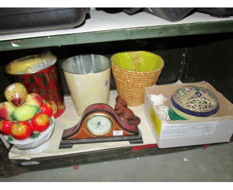 A shelf of miscellaneous items including clock