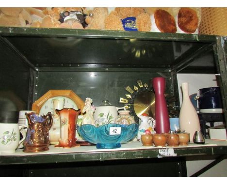 A shelf of miscellaneous items including clocks