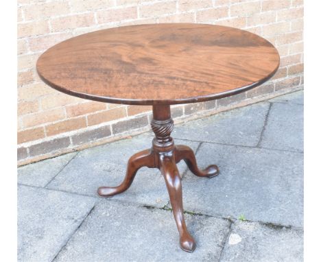 A GEORGE III MAHOGANY CIRCULAR TILT-TOP TABLE  raised on a turned column, with cabriole tripod supports and pad feet, 89.5cm 
