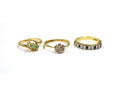 THREE 18CT GOLD &amp; GEM SET RINGS To include a three stone old step cut emerald ring with knife edge, wrap around shoulders