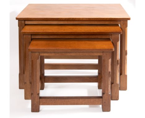 A ROBERT MOUSEMAN THOMPSON WORKSHOP (KILBURN) OAK NEST OF THREE TABLES  each with an adzed rectangular top, octagonal support