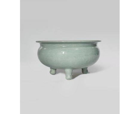 A CHINESE CELADON TRIPOD INCENSE BURNER 19TH CENTURY Carved with a scroll of flowering peony beneath bands of ruyi-heads and 