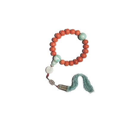 A CHINESE CORAL AND JADEITE ROSARY BRACELET QING DYNASTY The graduated coral beads divided by two circular jadeite beads, one