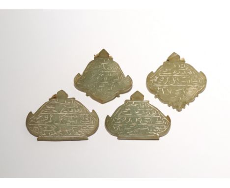 FOUR SMALL ISLAMIC CELADON JADE PLAQUES 19TH CENTURY Each formed as a lantern and carved with calligraphy, 4.8cm max. (4) Pro