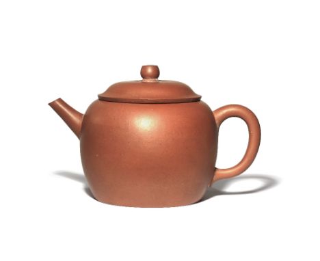 A CHINESE YIXING TEAPOT AND COVER QING DYNASTY The plain ovoid body with a loop handle and tapering spout, the base incised w