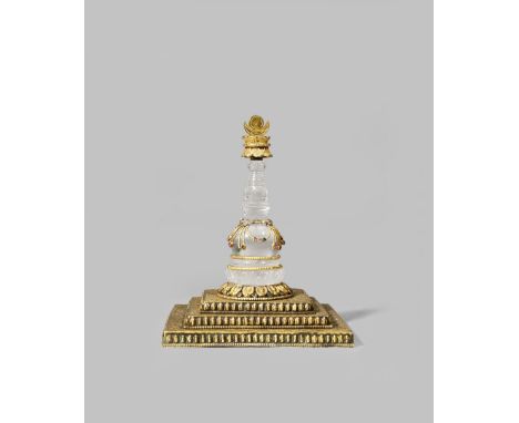 A NEPALESE ROCK CRYSTAL AND GILT-COPPER MODEL OF A STUPA 19TH/20TH CENTURY The crystal pillar mounted with a gilt-copper fini