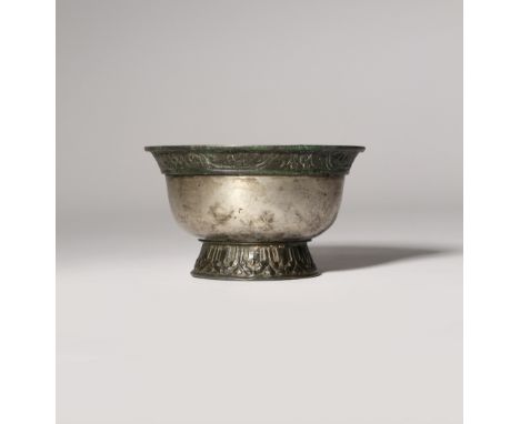 A SMALL CHINESE METAL ALLOY CUP TANG DYNASTY OR LATER The U-shaped body supported on a spread foot decorated with a band of l