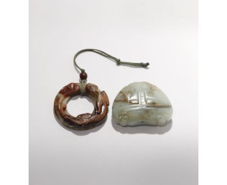 TWO CHINESE JADE CARVINGS QING DYNASTY One a heart-shaped bead carved with a stylised taotie mask head, the other a ring carv