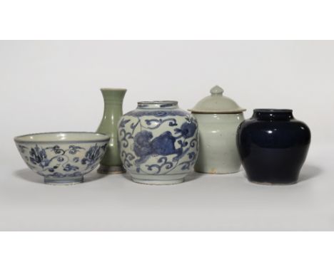 FIVE CHINESE CERAMIC ITEMS MING DYNASTY Comprising: an ovoid blue glazed jar, a vase with a crackled celadon glaze, a jar and