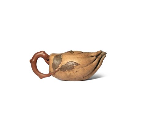 A CHINESE YIXING 'FINGER CITRON' TEAPOT AND COVER QING DYNASTY Formed as a finger citron with textured skin, the handle mould
