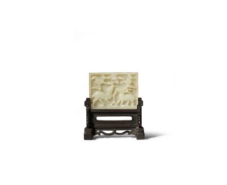 A CHINESE CELADON JADE RECTANGULAR PLAQUE MING/QING DYNASTY Carved in relief with a stag and a doe beneath ruyi-shaped clouds