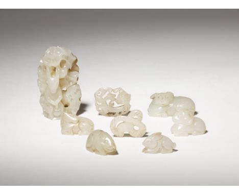 EIGHT SMALL CHINESE PALE CELADON JADE CARVINGS QING DYNASTY One depicting a rabbit pounding the Elixir of Life, the others fo