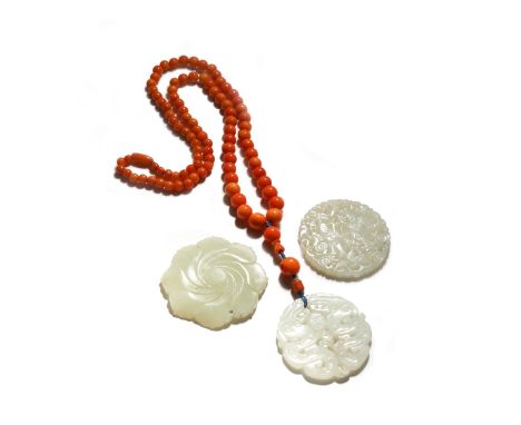 THREE CHINESE CELADON JADE PENDANTS QING DYNASTY/REPUBLIC PERIOD One carved in openwork with figures and a bird, another with