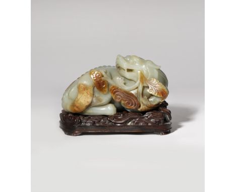 A LARGE CHINESE CELADON JADE CARVING OF A MYTHICAL BEAST QING DYNASTY OR LATER The lion-like creature carved in a recumbent p
