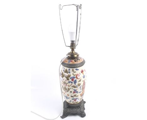 A early 20th century lamp base by R Ditmar of Wien. The pottery body with floral spray decoration and metal mounts, raised on