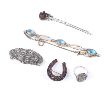 A small collection of jewellery to include a Bohemian garnet horseshoe brooch. A Celtic oval smokey quartz wire-twist brooch;