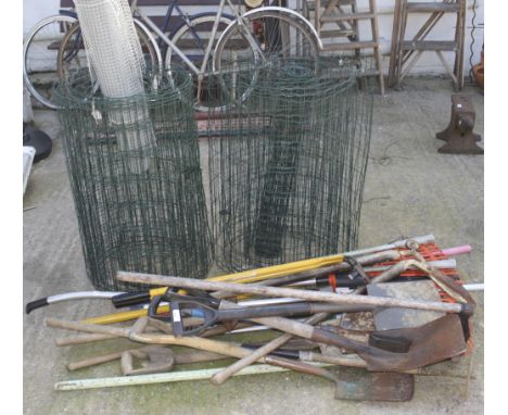 An assortment of gardening tools and three lengths of wire. The tools including spades, rakes, clippers, etc. 