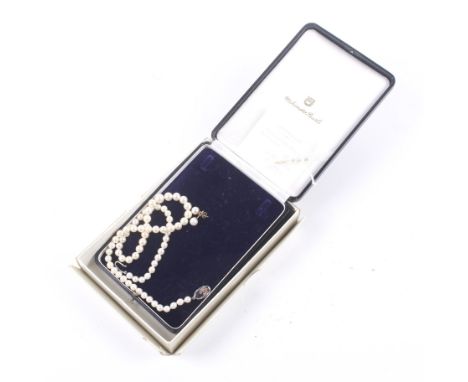 A cultured-pearl single row necklace and a pair of matching stud earrings. The necklace of seventy cultured-pearls graduated 