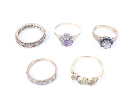 Five vintage 9ct gold and gem set dress rings. Comprising; a sapphire and  diamond cluster ring, size H, an amethyst and tiny