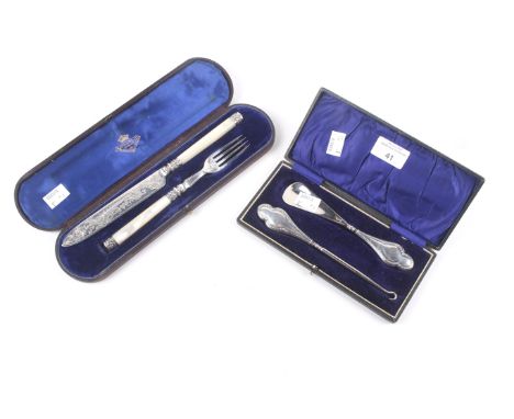 A silver handled shoe horn and boot hook. The shaped handles with laurel borders and engraved with a foliate script initial, 
