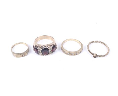 Four vintage gold and gem set rings. Comprising a tiny round cabochon tigers eye ring on a rope-twist shank with hallmarks fo