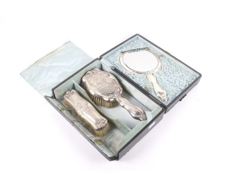 An Edwardian silver mounted shaped-oblong three piece dressing table set. Each embossed with galleons in full sail. Comprisin