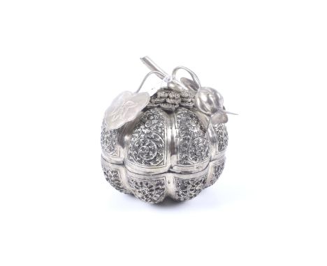 A large white metal pumpkin-shaped box and cover. With lotus leaf and bud finial and embossed with flowers and spiral scrolli