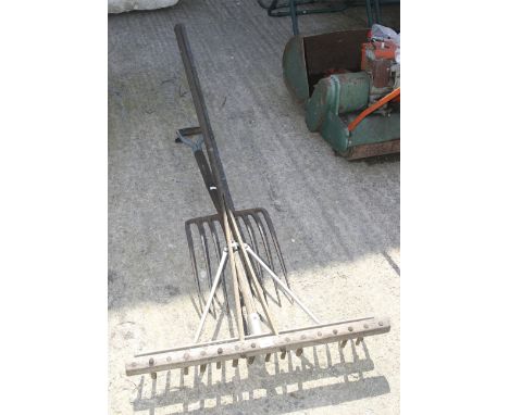 Two vintage garden tools. Comprising a pitchfork and a rake