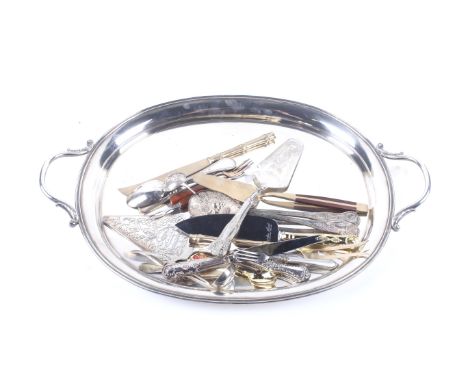 An assortment of silver plate including a twin handled tray. Together with a Scottish silver ladle, cake slices, flatware and