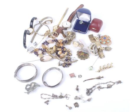 Two silver part foliate engraved hinged bangles and other items. Including various silver and white metal loose charms, vario