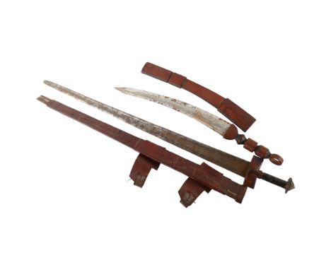 An antique Saharan Takouba sword in leather scabbard, and another North African short sword, longest 91cmTip of scabbard miss