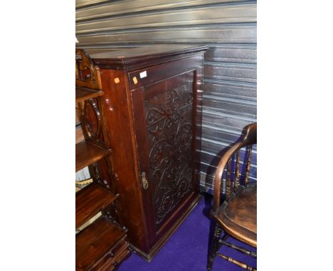 A Victorian stained frame side cabinet having carved panel decoration to door, width approx. 65cm