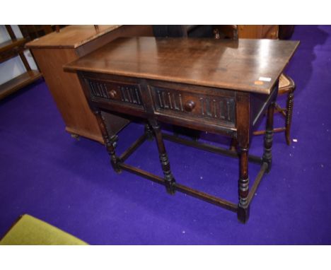 A Priory style oak hall table or dresser base having two frieze drawers , width approx. 107cm D46 H77cm , worm to back panel