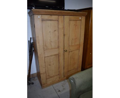 A wardrobe or cloak cupboard in stripped pine H154cm x W108cm x D45cm