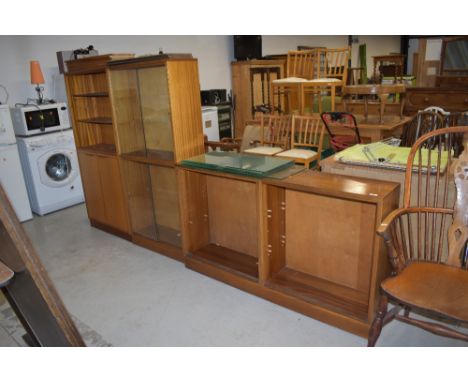 A set of three mid century display library or book shelf cabinets with glass fronts and teak or sapele carcass