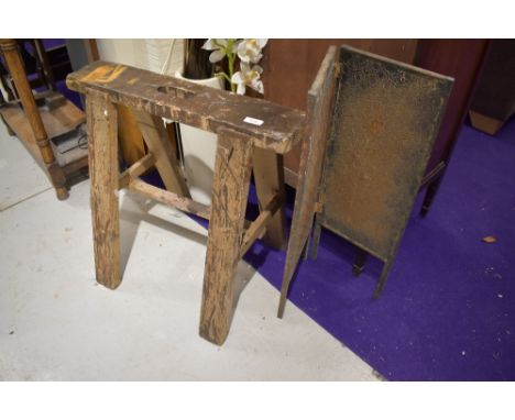 A trestle and copper fire screen