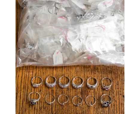 A collection of white metal rings and pendants stamped 925, the parcel comprises cluster, pave set, claw set, flush set rings