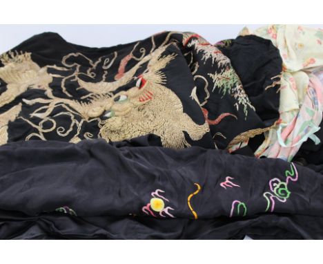 A collection of dressing robes to include a black Kimono style dressing robe with gold decoration of birds and dragons 1950, 