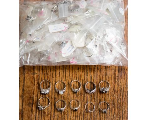 A collection of white metal rings and pendants stamped 925, the parcel comprises cluster, pave set, claw set, flush set rings