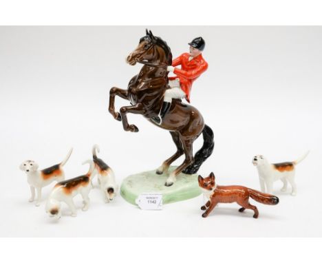 A Beswick hunting group, jockey on rearing horse, four dogs and fox 