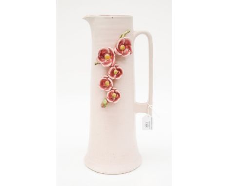 A Bretby Art Pottery jug No. 3462 in pale and cydamen pink with a swag of applied blossom 