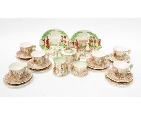 Tea service comprising of Falcon ware pottery - large teacups embossed with a bird, the handles are bird houses in beige and 