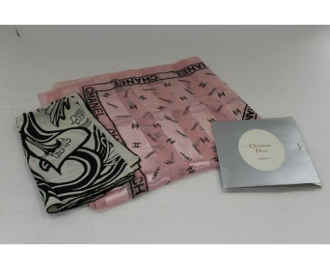 A Dior silk scarf in pink/blue in original sleeve 1950s/60s; together with a 1980s large Chanel scarf in pink with black writ
