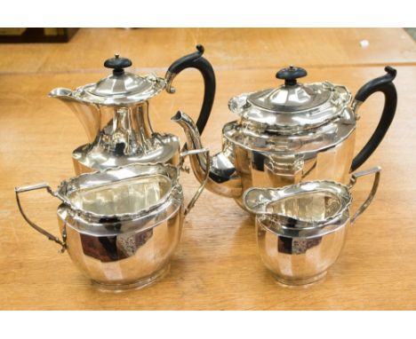A George V silver boat-shape, four piece silver tea service, each piece having wavy raised edge and faceted body approx. 46 o