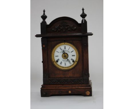 A Fattorini and Sons patent automatic alarm clock, Bradford Pat. 16226 oak cased, pendulum and key within (loud alarm) circa 