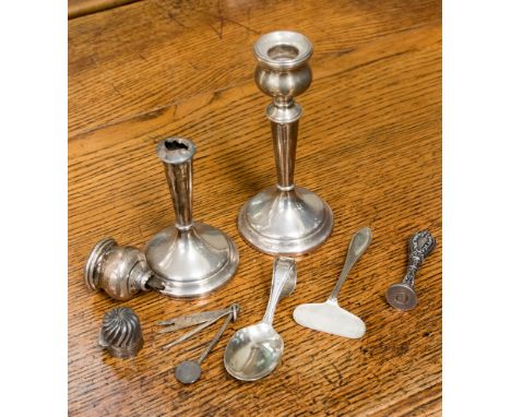 A child's silver spoon and 'pusher', Birmingham 1938 with a silver pipe pocket tool, a silver handled seal, silver candlestic