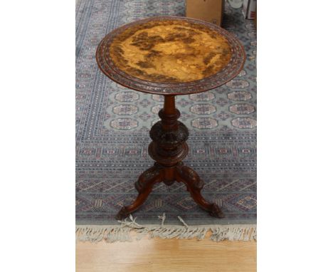 An Edwardian walnut pedestal wine table, the circular top inlaid with marquetry, raised on an elaborate turned column, standi