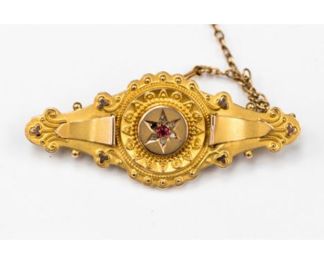 A yellow metal ring having diamond to centre with triangle diamonds on each shoulder, the diamonds set in white metal